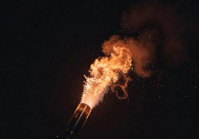 Glossy Orange Signal Flare Lighting the Dark Sky